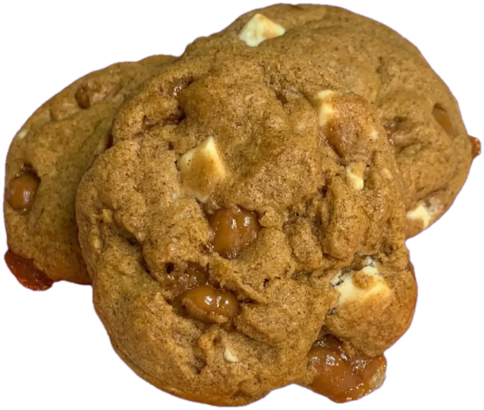 A stack of three Pumpkin Season cookies with white chocolate chunks and melted caramel